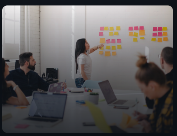 Team brainstorming session with sticky notes and whiteboard